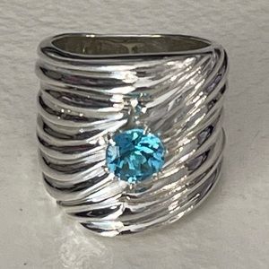 Custom piece round blue topaz in silver wide band